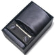 Black textured tie set with tie clip and pocket square in a box on a white background
