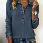 Woman wearing a blue ribbed sweater with button details and matching jeans.
