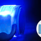 Blue glowing wristband with star pattern on a dark background