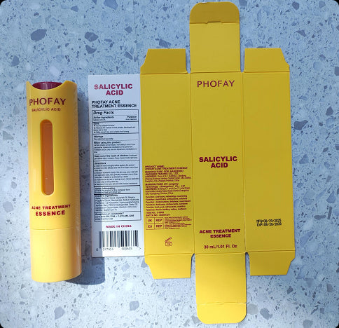 Yellow PHOFAY salicylic acid treatment essence packaging on a blue speckled surface