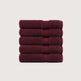 A stack of five folded bath towels in a deep burgundy color, arranged vertically against a light gray background. Pure Cotton Bath Towel Set – Burgundy & Turquoise (74x33cm to 170x95cm)