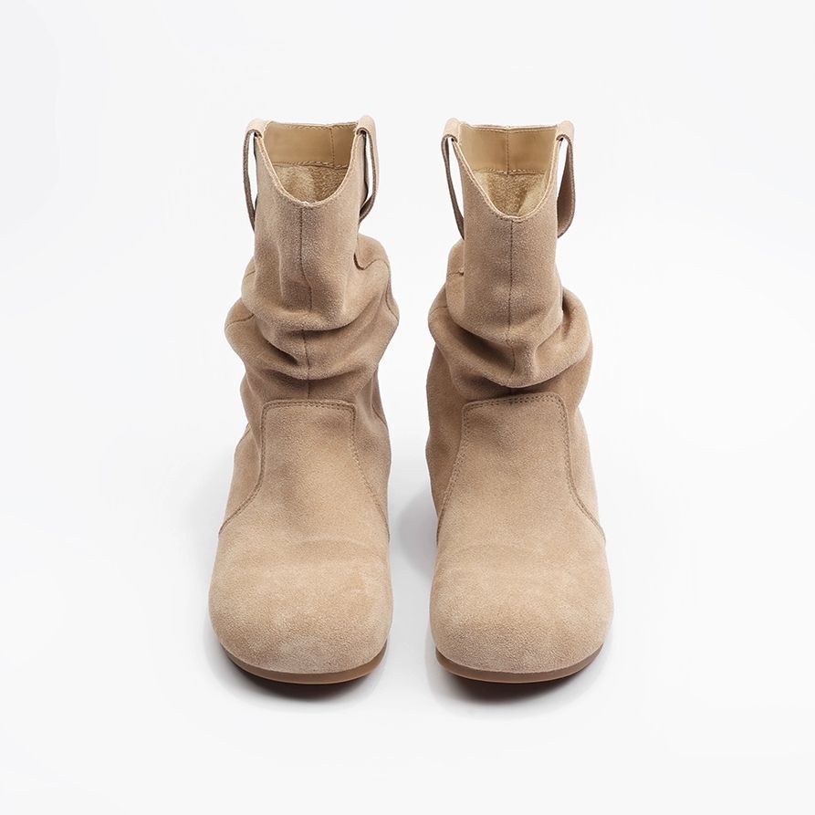 Paire de bottines beiges sur un fond blanc