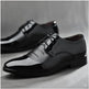 Black dress shoes on a gray background