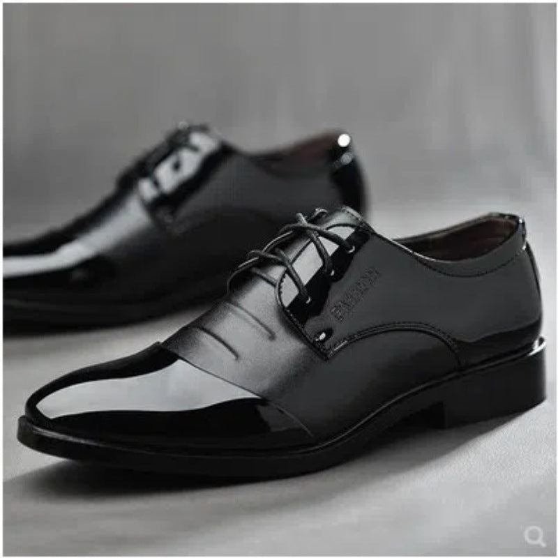 Black dress shoes on a gray background