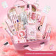 Pink stationery set with various items including pens, calculators, and notebooks on a pink background.