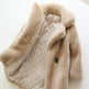 Beige quilted jacket with fluffy collar on a white background