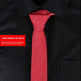 Red tie on a black shirt with a red label displaying an item number.