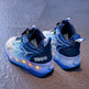 Blue children's sneakers with LED lights on a dark surface