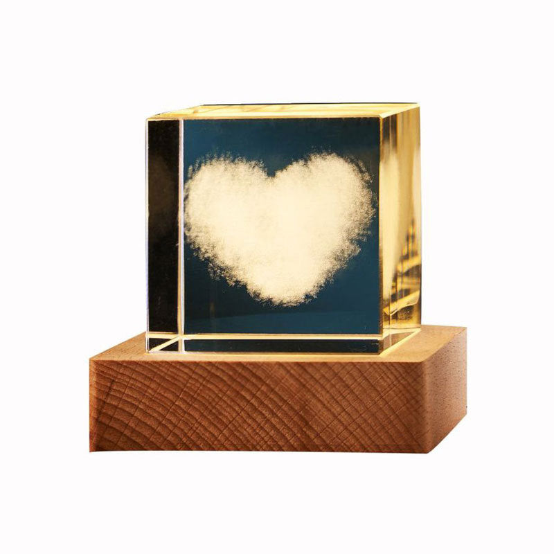 Decorative object with a heart-shaped light inside a wooden base and gold frame.