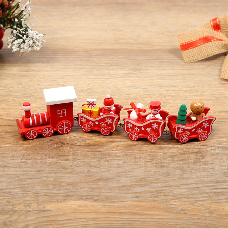 Wooden toy train set with Santa Claus and Christmas trees on a wooden surface