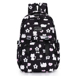 Black backpack with white cat and flower pattern on a white background
