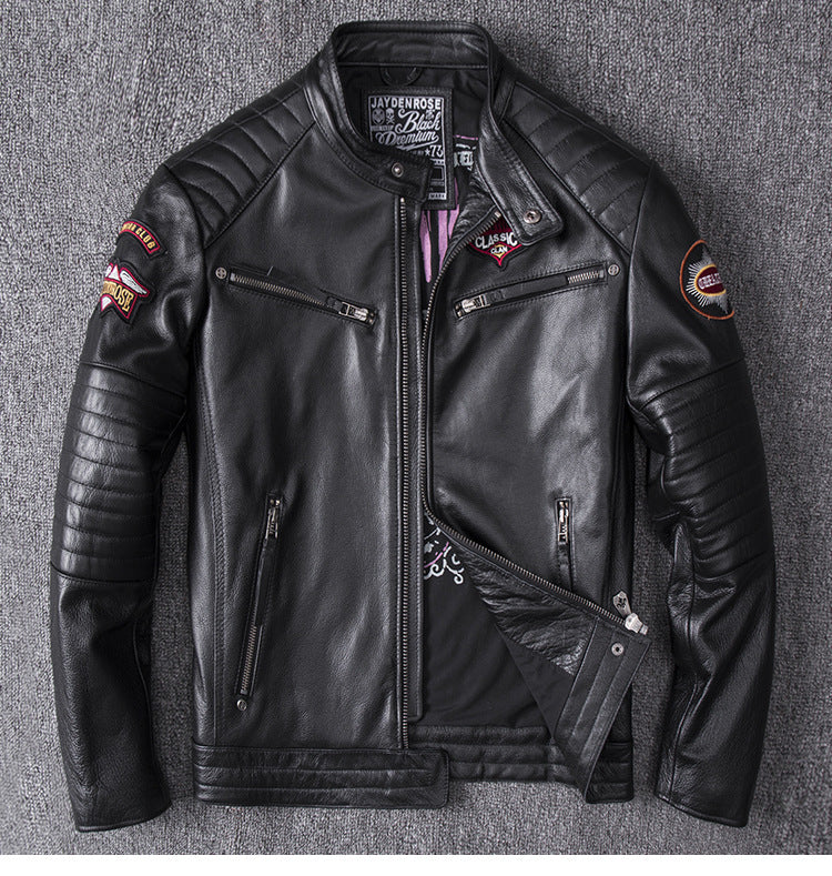 Black leather jacket with patches on a gray background