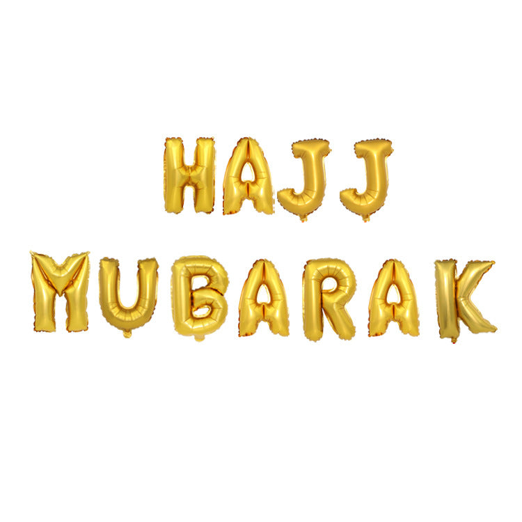 Gold foil balloon letters spelling out 'HAJJ MUBARAK' in two lines on a plain white background.