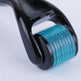 Close-up of a black and teal roller device on a light gray background