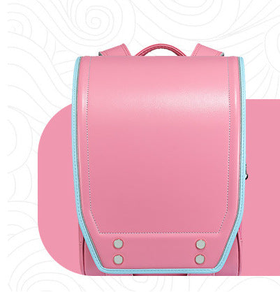 A pink school backpack with a structured flap front, light blue piping trim, and silver metal rivets, shown against a white background with a pink graphic shape behind it.