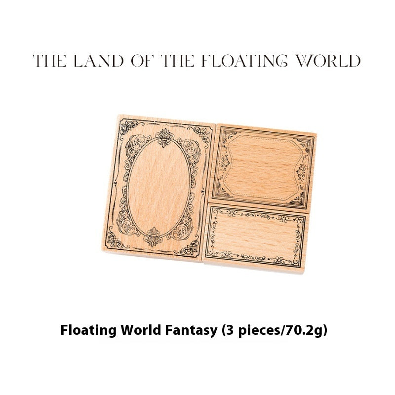 Three miniature wooden cards with engraved fantasy designs, including an oval frame and two rectangular labels, displayed on a white background with text reading 'THE LAND OF THE FLOATING WORLD' and 'Floating World Fantasy (3 pieces/70.2g)'.