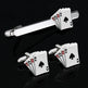 Silver playing card-themed cufflinks and tie clip on a black background
