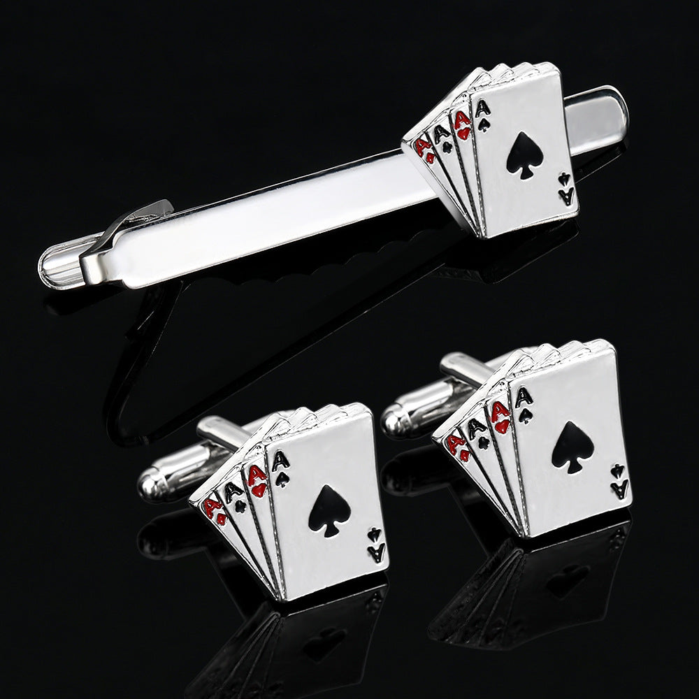 Silver playing card-themed cufflinks and tie clip on a black background