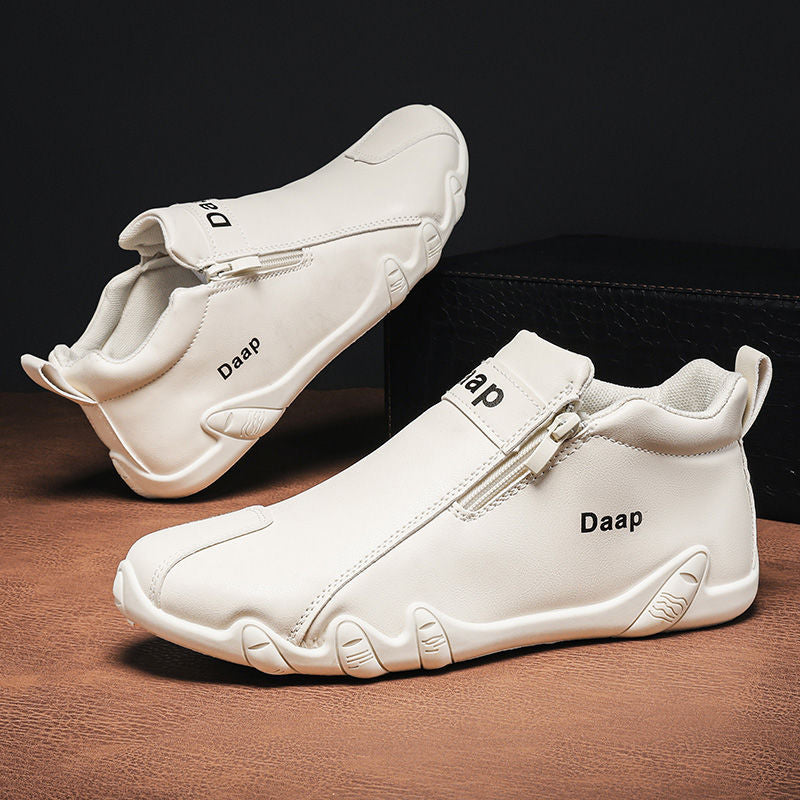 White sneakers with 'Daap' branding on a brown surface