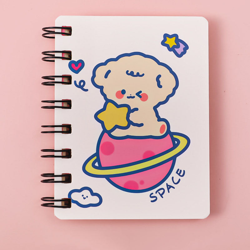 Notebook with a cute illustration of a baby on a planet, holding a star, on a pink background.