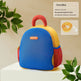Colorful backpack with red handle on a beige background