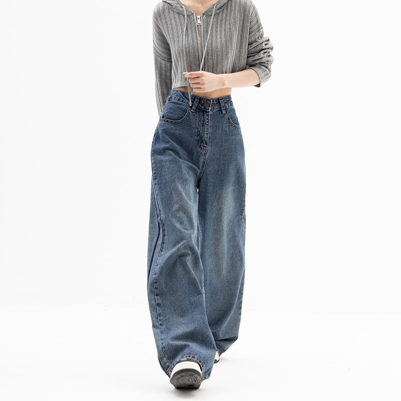 Person wearing a gray hoodie and blue jeans on a white background
