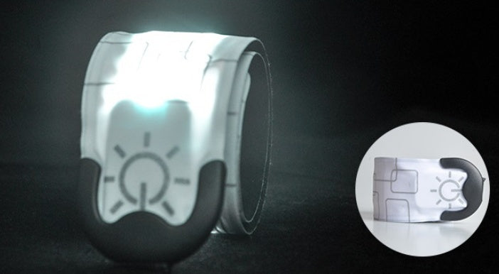 Reflective safety wristband with embedded light on a dark background
