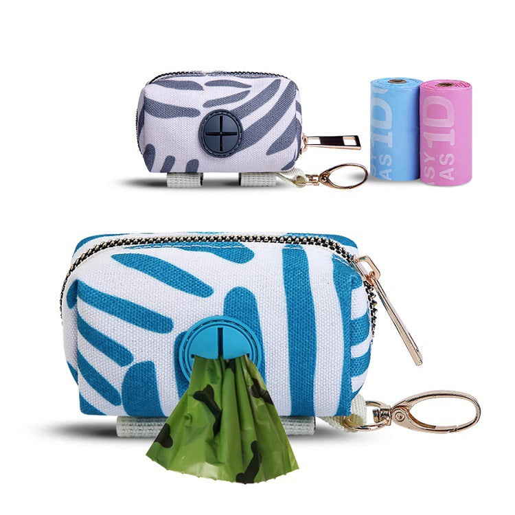 Reusable trash bag dispenser with patterned design, keychain, and two rolls of trash bags on a white background.