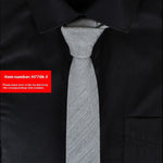 Gray tie on a black shirt with a red item number label.