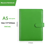 Green notebook with dimensions labeled on a white background