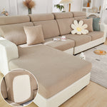 Beige sectional sofa with textured cover and decorative pillows in a living room setting.