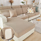 Beige sectional sofa with textured cover and decorative pillows in a living room setting.