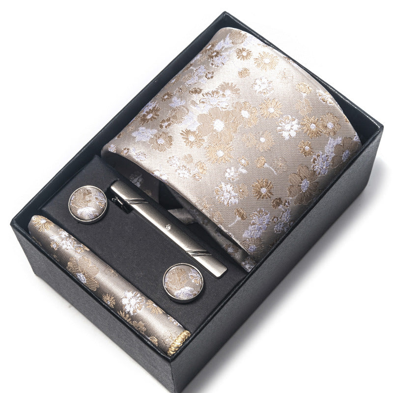 Floral tie set with cufflinks and tie clip in a black box on a white background