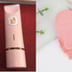 Pink grooming tool and mitt on a white background