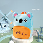 Plush toy koala with an orange pouch labeled 'koala' in a playful setting with a windmill.