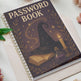 Password book with witch hat, book, and candle design on a white surface