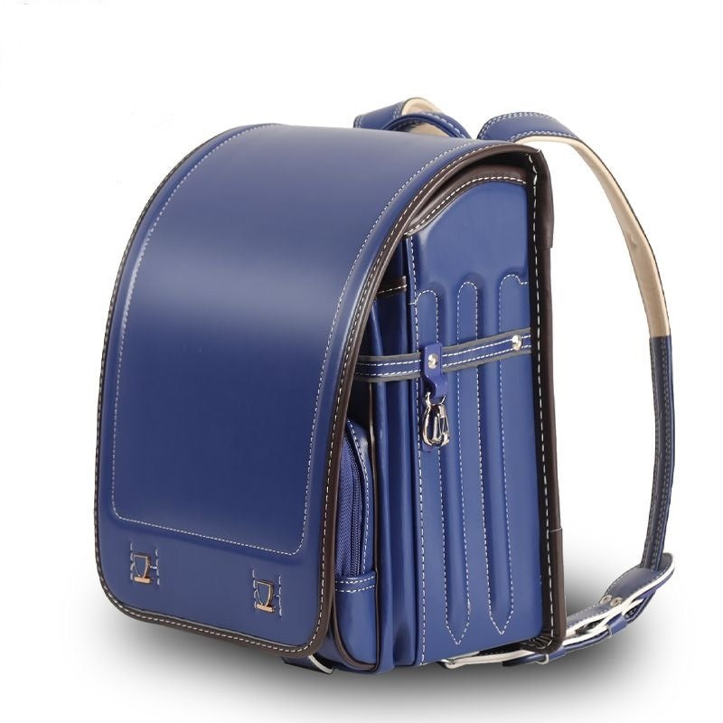 Blue leather backpack with a strap on a white background
