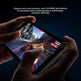 Person holding a smartphone playing a game with text about processor, RAM, and operating system.