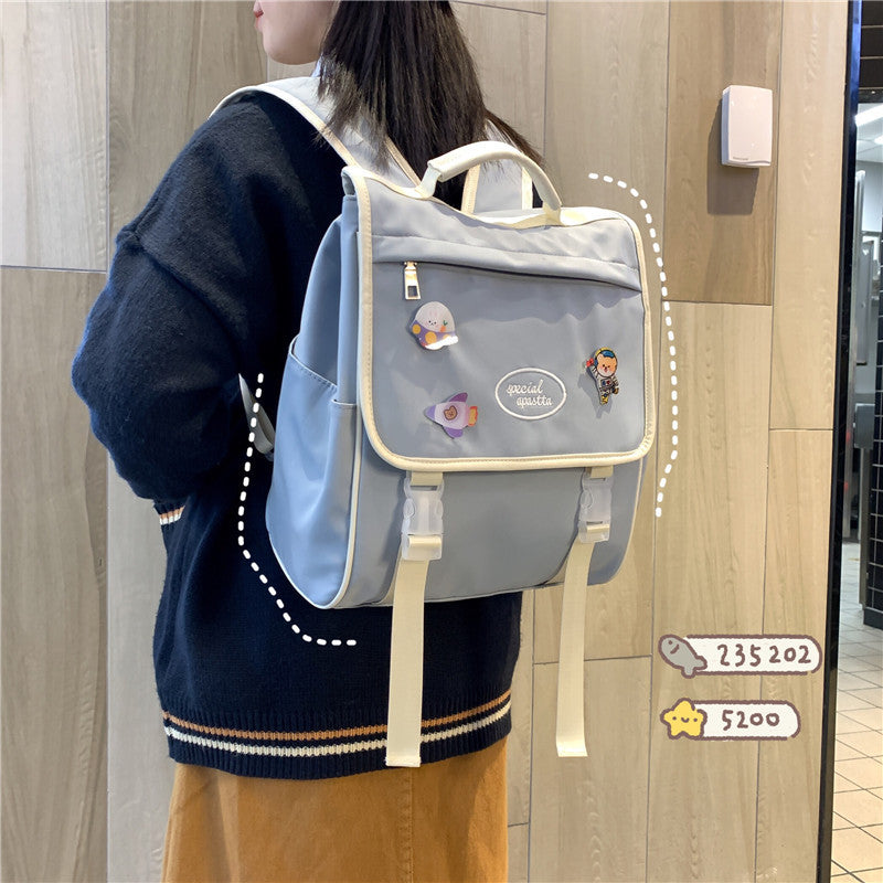 Person wearing a gray backpack with cartoon characters on a wooden floor.
