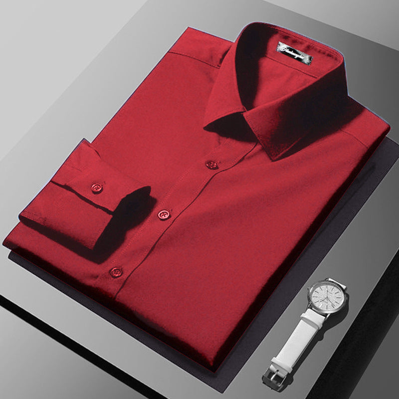 Folded red shirt with a white watch on a gray surface