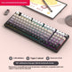 Mechanical keyboard with RGB lighting on a desk with a tablet and smartphone in the background.