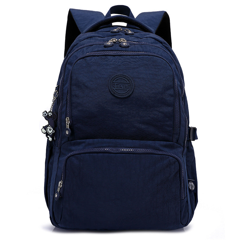 Navy blue backpack with multiple zippers on a white background
