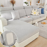 Gray sectional sofa with decorative pillows in a living room setting.