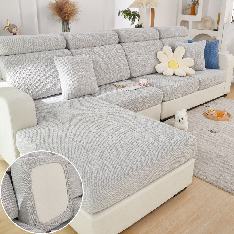 Gray sectional sofa with decorative pillows in a living room setting.