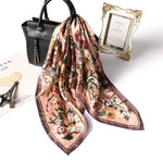 Floral patterned scarf with a black handbag and 'Save the Date' frame on a white background