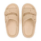 Pair of beige sandals with buckle straps on a white background
