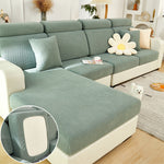 Green sectional sofa with a close-up of the fabric texture in a living room setting.