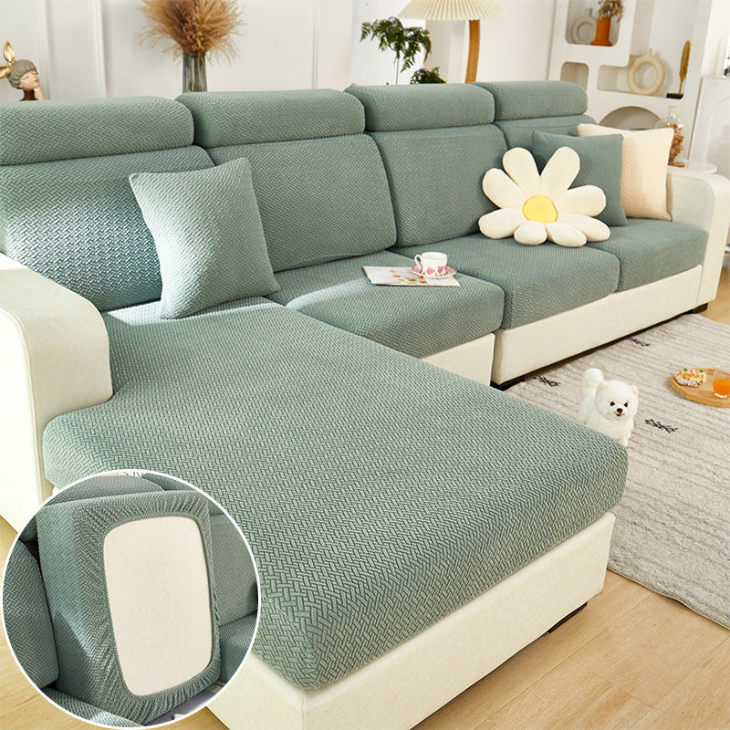 Green sectional sofa with a close-up of the fabric texture in a living room setting.