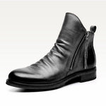 Black leather ankle boot with a zipper on a white background