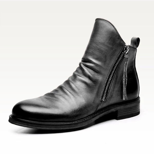 Black leather ankle boot with a zipper on a white background